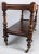 French mahogany server or dumbwaiter, circa 1830. This two tier dumbwaiter with turned columns stands on turned legs with...