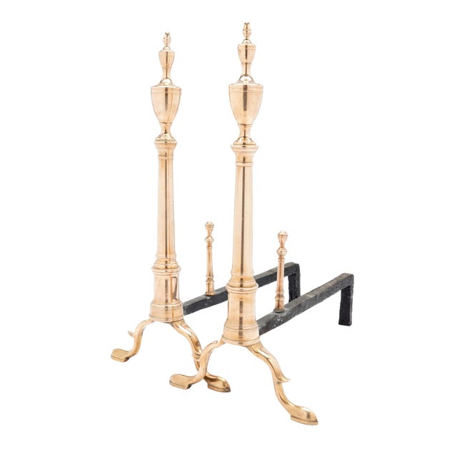American cast bell metal columnar andirons with double urn finials. The columns are supported by arched slipper feet...
