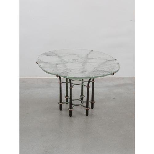 Designed like a flower, hand-formed wrought bronze base with a floating glass top by Lothar Klute - 1980s, a Germany...