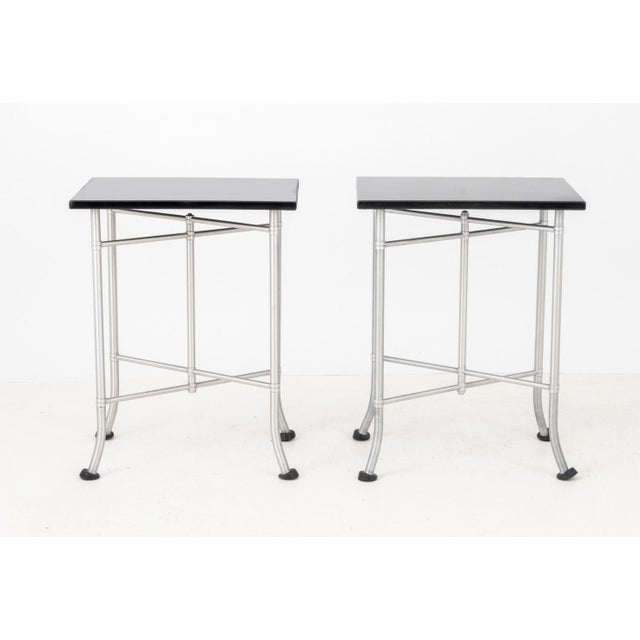 Warren McArthur (American, 1885-1961) Pair of Art Deco Bed Side Tables, with black Bakelite tops above aluminum bases. 30"...