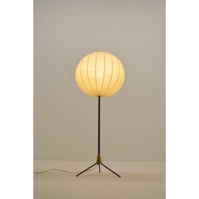 Beautiful mid-century tripod cocoon floor lamp from the 1960s. The shade, reminiscent of George Nelson's "bubble lamp,"...
