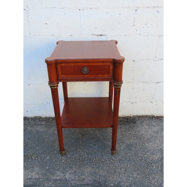 This beautiful Nightstand is made of wood, cherry, and veneer. It was made by Ethan Allen and it is labeled. This classic...