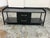Design Plus Gallery presents an Industrial Metal Entry Bench. The bench has a black metal frame with a tray-style top,...
