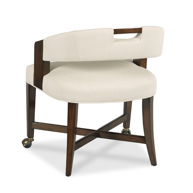 A curved upholstered top rail is fitted with a convenient handle resting above an upholstered seat raised by squared...