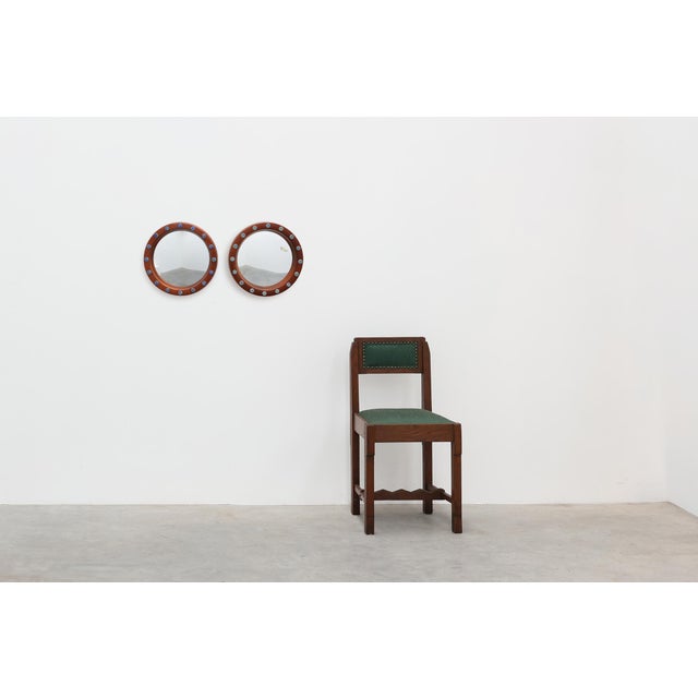 A striking pair of round wall mirrors designed and produced by Deknudt in Belgium during the 1960s. Each mirror features a...