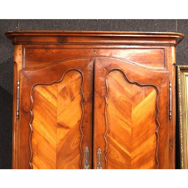 A beautiful and generously proportioned 19th-century French Provincial walnut armoire, featuring elegant Louis XV-inspired...