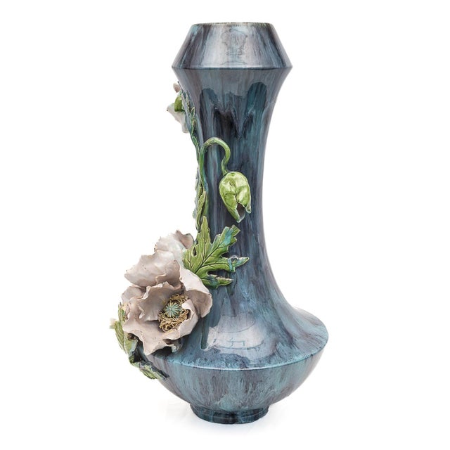 Large Art Nouveau majolica vase. Gray-marbled, glazed gray-blue background. Decorated with leaves and pink flowers....