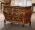 Crafted in Bordeaux, France circa 1760, this elegant antique “Commode Tombeau” exemplifies the graceful movement and...