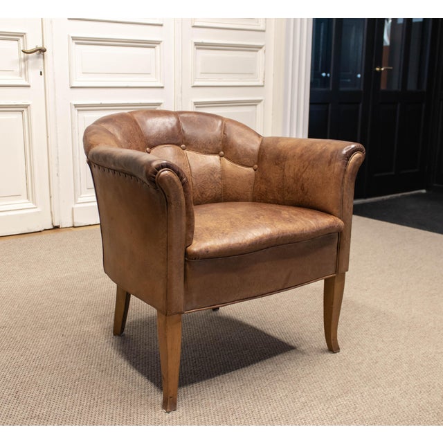 Elegant and refined Swedish “Tiger” club chair from the 1940s, executed in rich dark brown leather. This slender model...