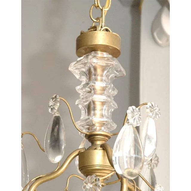 Elegant chandelier by Maison Baguès. Six lights with clear crystal tear drops, daggers and rosettes.