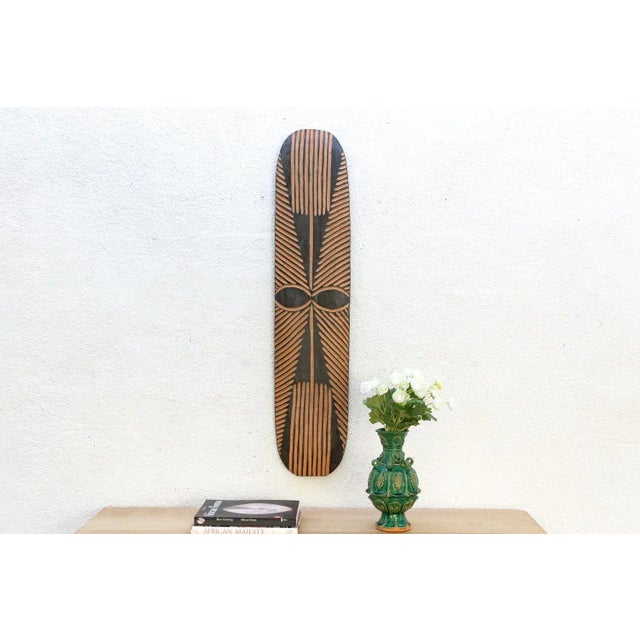 This striking piece is a profound invitation to bring history and strength into your home. This hand-carved African Tribal...