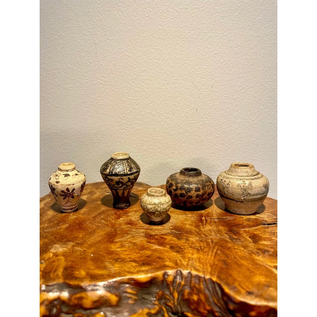 A charming group of tiny ceramic vases or vessels made in the Sukhothai period in Thailand from the 13th-15th centuries....
