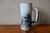 Unique and striking, this Vallauris stoneware carafe tells the story of the creative adventure of the ceramic workshops of...