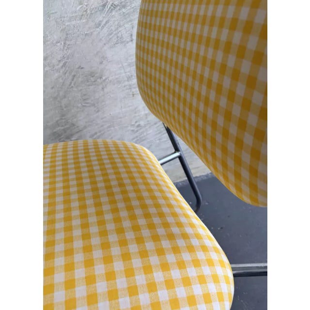 Small armchair seat reupholstered with plaid fabric.