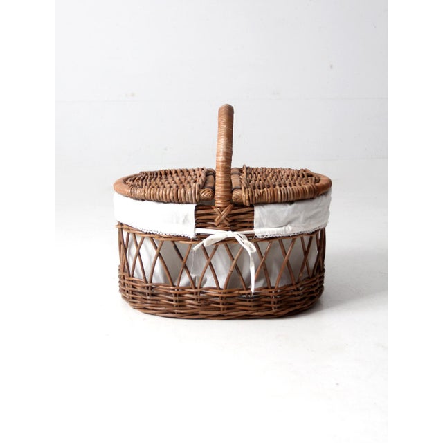 This is a vintage wicker picnic basket with removable lining. The large airy wicker basket features a double hinged lid...