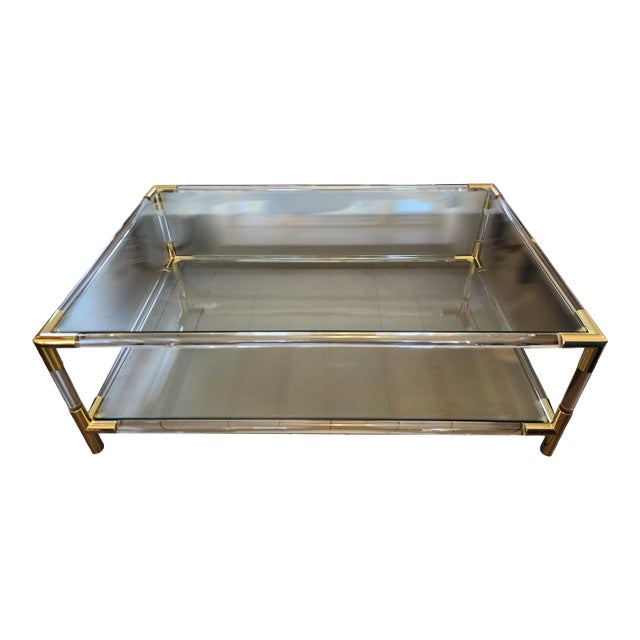 Dimensions: 48l x 30 x 15.25" Rectangle Glass Lucite Gold Coffee Table Made with thick lucite rods on all sides, features...