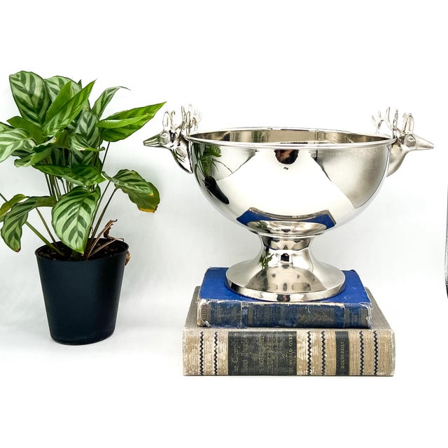 Gorgeous, mid-late 20th century polished stainless steel pedestal bowl featuring sculptural deer head handles with...