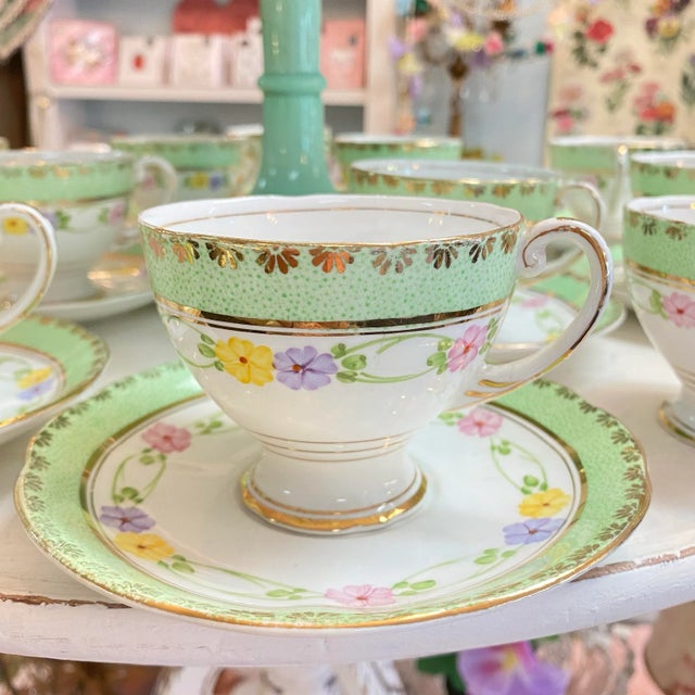 Very elegant hand painted set of 11 tea cups and saucers. Made in England Bone China by Royal Standard. The initials of...