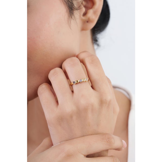 This five-stone band ring showcases 0.55 carats of natural multi-color diamonds, set in 14K yellow gold. Each mixed-size...
