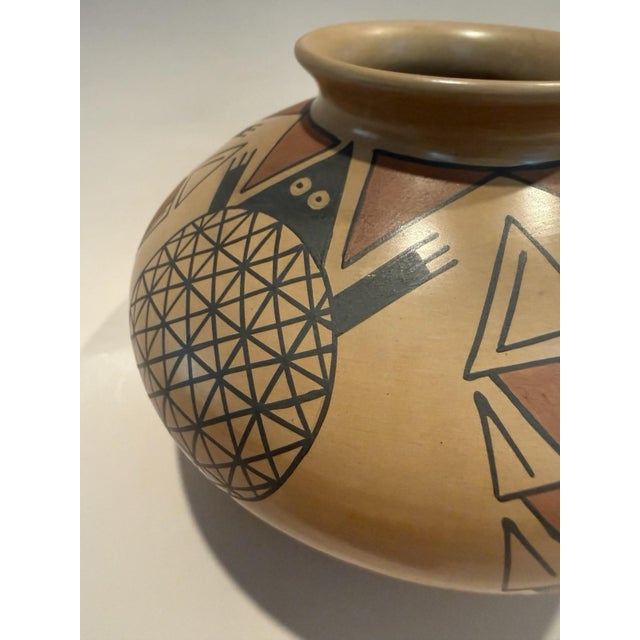 The product is a handmade piece of Mata Ortiz pottery signed by Miguel Lopez, a renowned Mexican artist. This piece of...