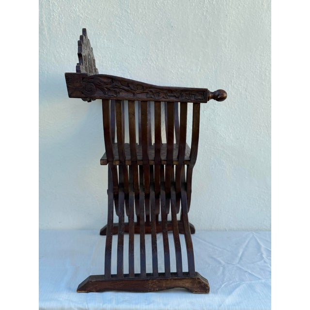 beautifully sculptural Savonarola side chair . 18” seat height . 36” h by 24” wide at arms .