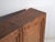 Tall chinese sideboard in carved pine, with a two-door, and two inner shelves, is decorated with geometric motifs,...