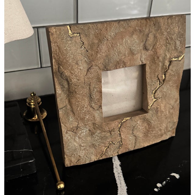 An industrial modern stone picture frame with natural gilded veining. Sculptural, architectural, and refined.