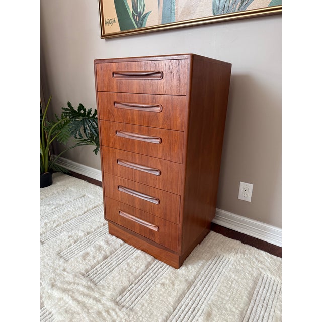 This tallboy dresser was designed by Victor B. ("VB") Wilkins for G Plan's "Fresco" line, made of teak wood with rounded...