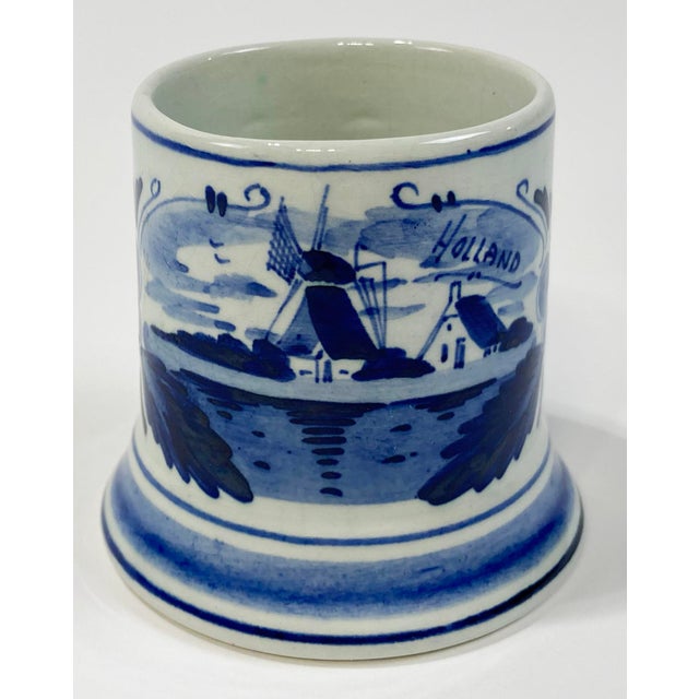 Vintage Delft hand painted porcelain vessel. Features classic blue and white with windmill scene and floral surround....