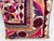 Elegant decorative pillow upholstered in a richly patterned Uzbek textile, featuring charming floral flowerhead motifs and...