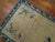 Long 1920s Chinese runner with a solid open field design with floral motifs in beige with a lovely floral border in navy...