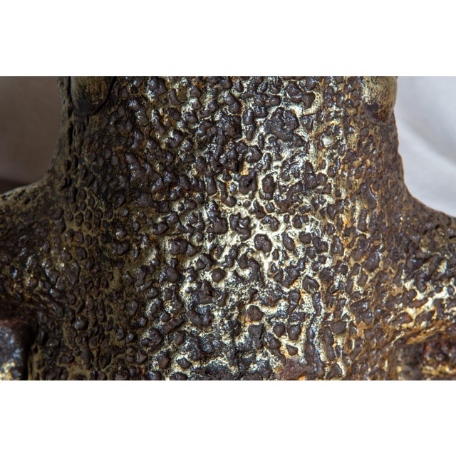 A fanciful gilt cast stone frog prince. He is croaching on his hind legs, wearing a crown and big smile. A fun addition to...