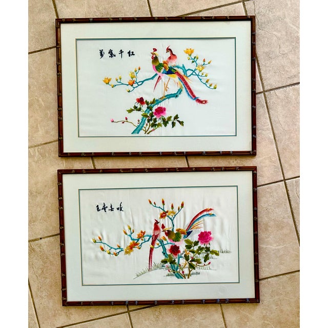 Beautiful framed pair of Silk Suzhou embroidery panels each depicting two colorful birds perched on blooming trees and...