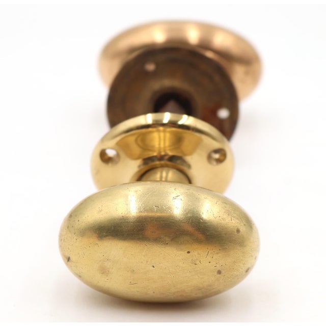 Vintage Classic passage door knob set made of brass with a polished brass and copper finish. The original mounting screws...