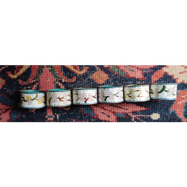 A beautiful set of six vintage Chinese cloisonné napkin rings features brass construction with enamel cloisonné in floral...