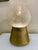 This is a table lamp featuring a crackled glass globe resting on a conical gilded aluminum base. The base has small...