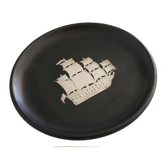 Offered is a rare decorative plate in Isolite (Swedish Bakelite) with a ship in Silver intarsia inlay. Made by silversmith...