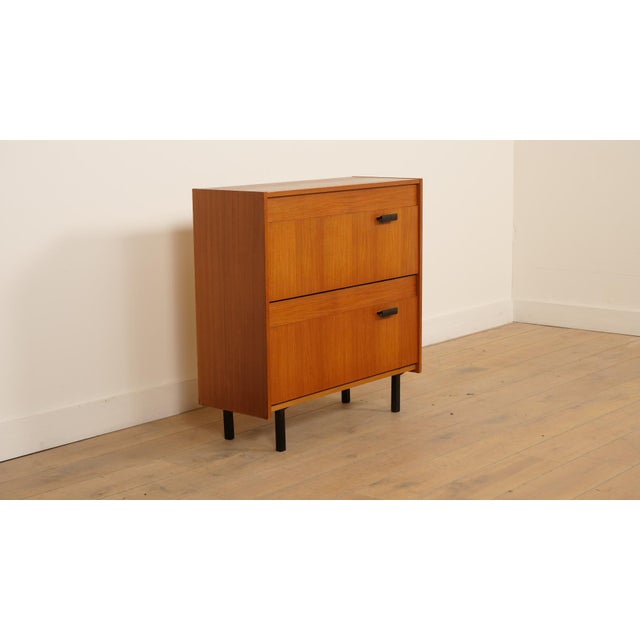 Discover our beautiful vintage teak shoe cabinet from the 1960s—a timeless piece that adds character to your interior....