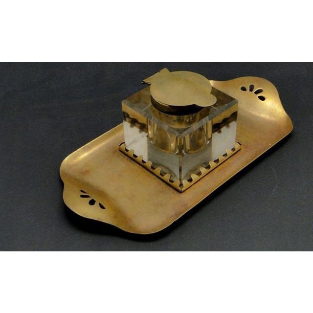 Inkwell produced at the beginning of the twentieth century in Vienna. It was made of brass and faceted glass. It is...