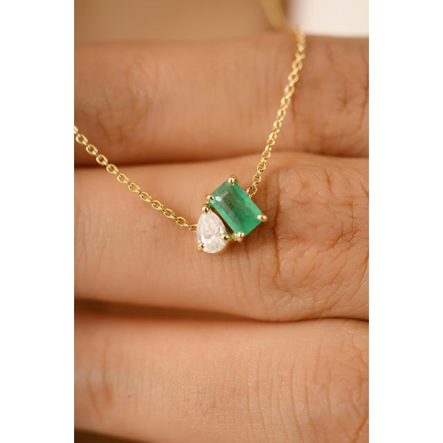 Crafted in elegant 14K yellow gold, this minimalist pendant necklace features a stunning 0.3 carat octagon-cut emerald...