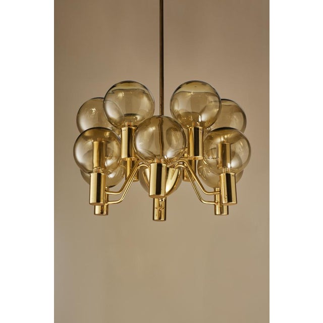 Produced by Hans-Agne Jakobsson AB in Markaryd, Sweden, 1960s. Frame in polished brass. Blown glass. This piece is...