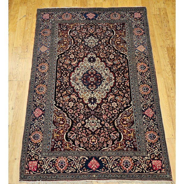 "Magnificent early 20th century Persian Kashan area rug, meticulously hand-knotted in a floral pattern. From the esteemed...