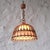 Bamboo and rattan ceiling lamp with a bell-shaped structure. It has a textured parchment diffuser and is beautiful when...