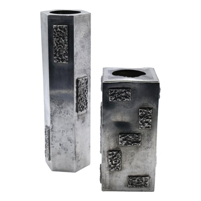 Pair of brutalist vases in 95% pewter, handmade. One vase is hexagonal and the other rectangular, both decorated with...