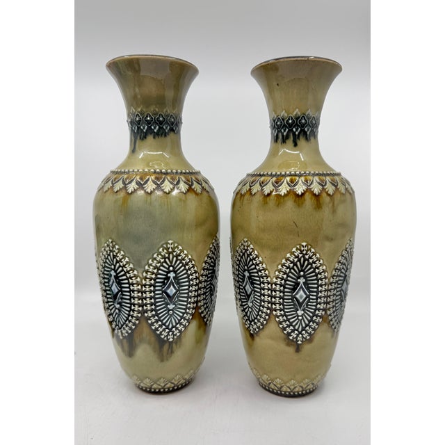 A nice pair of Doulton Lambeth Salt Glazed Stoneware vases with incised and applied decoration. There are both signed on...