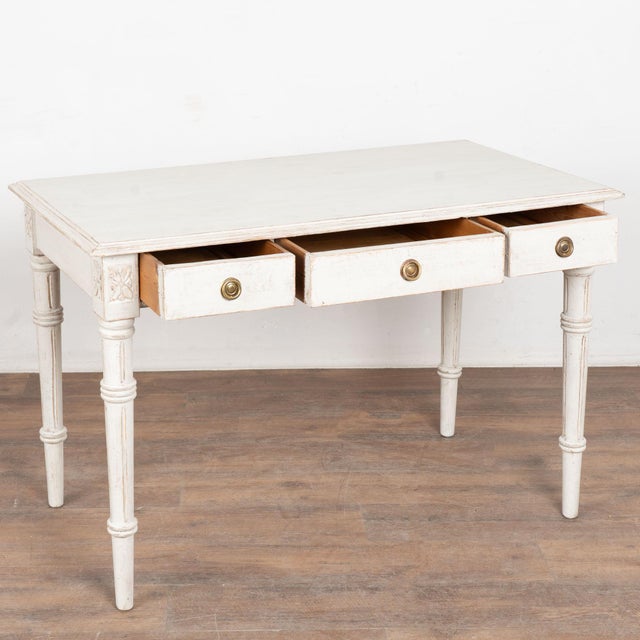 19th century Swedish Gustavian side table or desk, crafted in pine. The table features one large center drawer flanked by...
