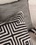 This throw pillow is a visually striking piece of home art, featuring a classic black and white color scheme. It is...