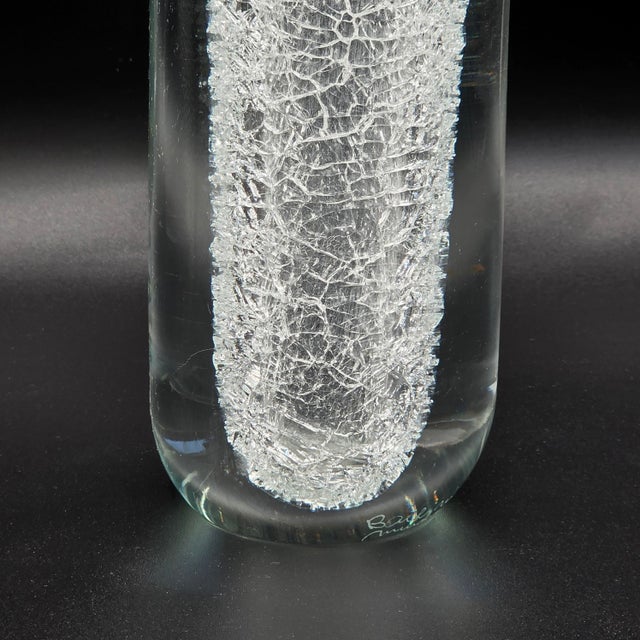 A striking vintage Alfredo Barbini Murano art glass vase featuring a tall, sculptural clear-glass form with a dramatic...