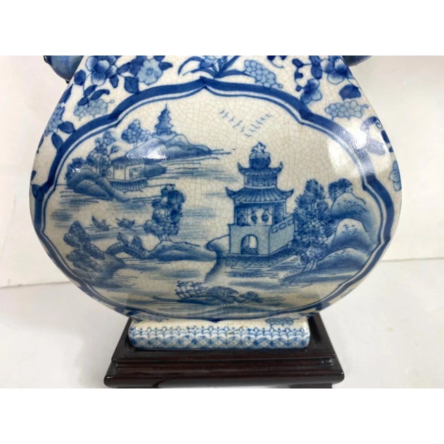 A pair of Asian blue & white table lamps with custom- made shade. The size of the lamp is 8"W, 14"H, 6"D.