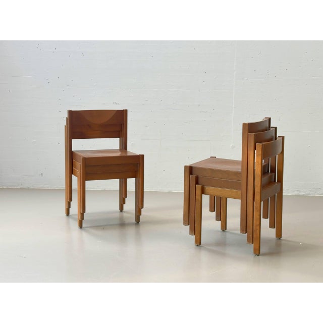 An elegant set of four stackable wooden chairs with a clean, architectural design. The chairs impress with their...
